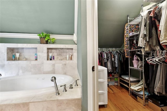 5878 General Diaz St, New Orleans, LA 70124 - bathroom with a bath, a walk in closet, and wood finished floors