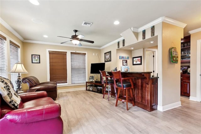 5878 General Diaz St, New Orleans, LA 70124 - living room with a dry bar, ceiling fan, light wood-style flooring, crown molding, and baseboards