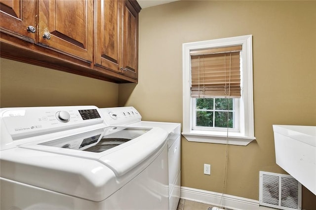 5878 General Diaz St, New Orleans, LA 70124 - laundry room with washing machine and clothes dryer, cabinet space, and baseboards