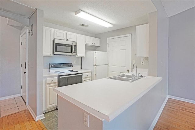 350 Emerald Forest Blvd Unit 9202, Covington, LA 70433 - kitchen featuring white appliances, a sink, a peninsula, light wood-type flooring, and baseboards