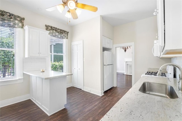 312 N Oak St, Hammond, LA 70401 - kitchen featuring white appliances, a sink, dark wood-style flooring, and healthy amount of natural light