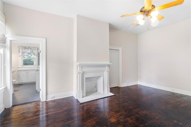 312 N Oak St, Hammond, LA 70401 - unfurnished living room with wood finished floors, a ceiling fan, a fireplace, and baseboards