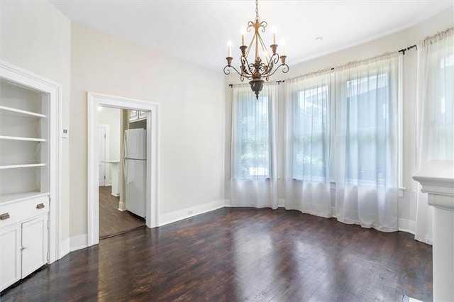 312 N Oak St, Hammond, LA 70401 - unfurnished dining area featuring a chandelier, plenty of natural light, and dark wood-type flooring