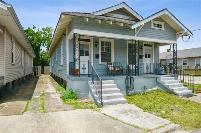 491113 Willow St, New Orleans, LA 70115 - shotgun-style home with a porch and driveway