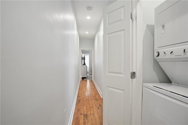 491113 Willow St, New Orleans, LA 70115 - laundry room with stacked washing machine and dryer, baseboards, light wood-style floors, and recessed lighting