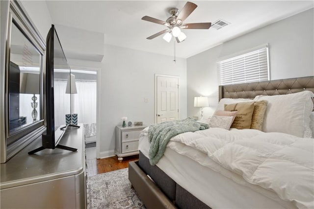 491113 Willow St, New Orleans, LA 70115 - bedroom featuring wood finished floors, ceiling fan, and baseboards