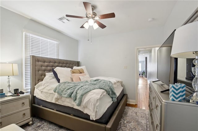 491113 Willow St, New Orleans, LA 70115 - bedroom with wood finished floors, ceiling fan, and baseboards