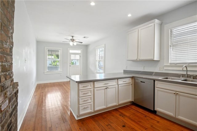 491113 Willow St, New Orleans, LA 70115 - kitchen featuring dishwasher, a sink, ceiling fan, dark wood finished floors, and a peninsula
