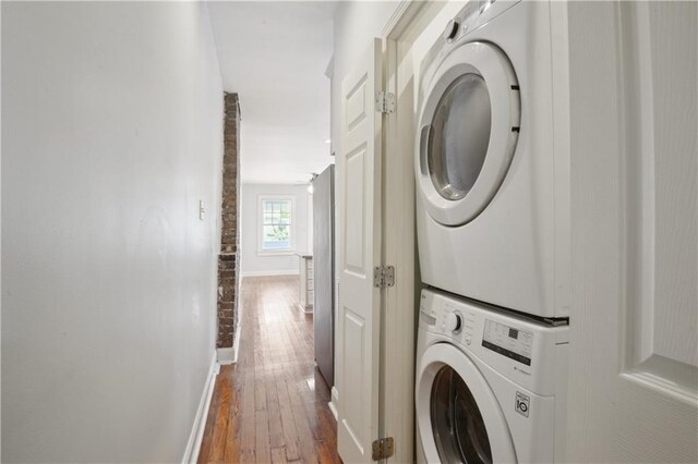 491113 Willow St, New Orleans, LA 70115 - washroom with stacked washer / drying machine, baseboards, and wood-type flooring