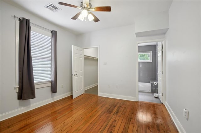 491113 Willow St, New Orleans, LA 70115 - unfurnished bedroom featuring hardwood / wood-style floors, baseboards, a ceiling fan, and ensuite bath