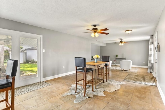 6020 Loraine St, Metairie, LA 70003 - dining space featuring ceiling fan, baseboards, light tile patterned floors, and a textured ceiling