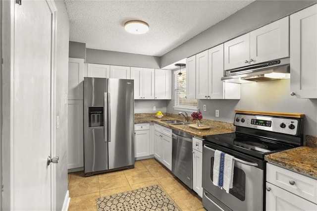 6020 Loraine St, Metairie, LA 70003 - kitchen with appliances with stainless steel finishes, under cabinet range hood, white cabinetry, a sink, and a textured ceiling