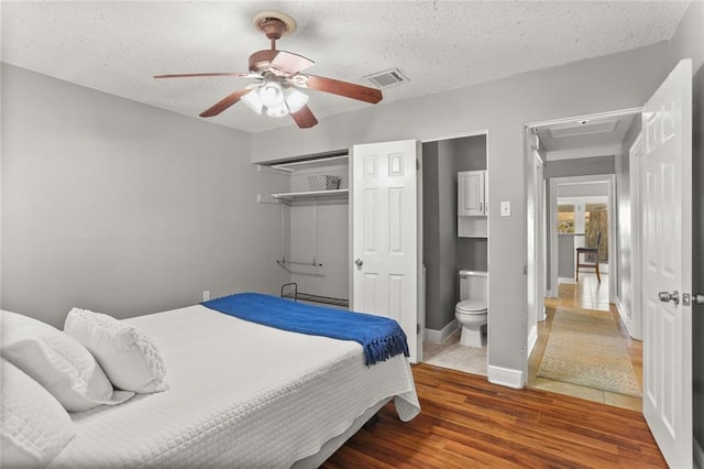 6020 Loraine St, Metairie, LA 70003 - bedroom featuring wood finished floors, ceiling fan, a textured ceiling, and baseboards