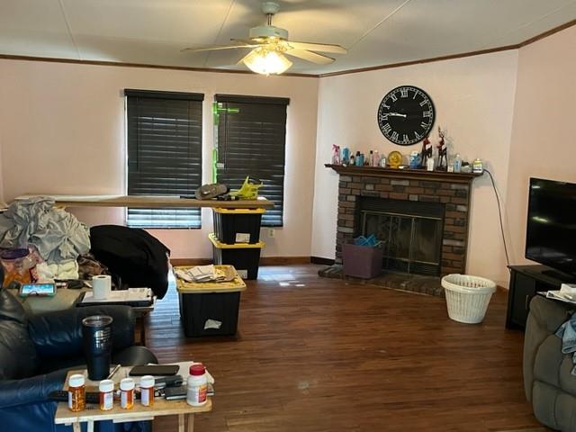 36241CENTRALAVENUE Central Ave, Pearl River, LA 70452 - living room with ceiling fan, wood finished floors, a glass covered fireplace, and ornamental molding