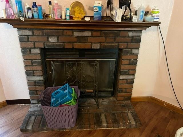 36241CENTRALAVENUE Central Ave, Pearl River, LA 70452 - detailed view of baseboards, a fireplace, and wood finished floors