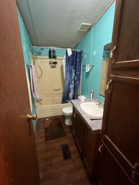 36241CENTRALAVENUE Central Ave, Pearl River, LA 70452 - bathroom featuring a textured ceiling, wood finished floors, vanity, toilet, and shower / tub combo with curtain