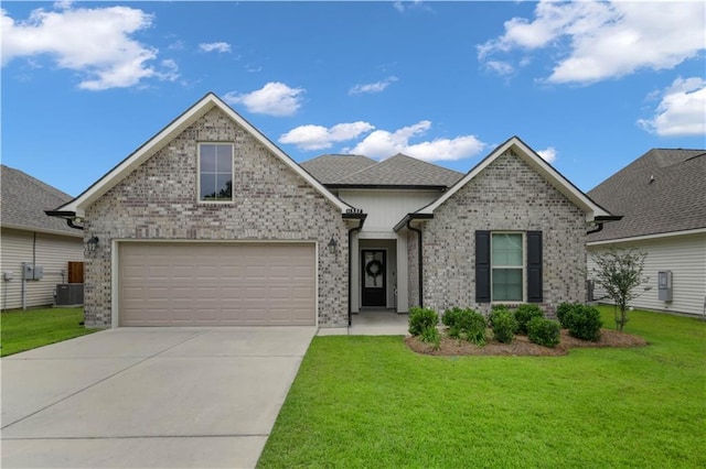 11537 Woodbluff Dr, Covington, LA 70433 - view of front of property with cooling unit, a front yard, concrete driveway, and brick siding