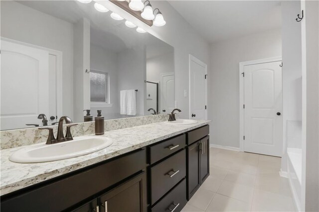 11537 Woodbluff Dr, Covington, LA 70433 - full bath featuring double vanity, a shower, tile patterned flooring, a bath, and baseboards