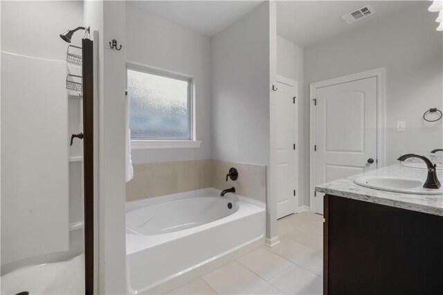 11537 Woodbluff Dr, Covington, LA 70433 - bathroom featuring tile patterned flooring, a bath, and double vanity