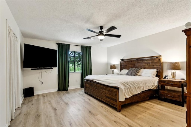 352 Moonraker Dr, Slidell, LA 70461 - bedroom with light wood-style floors, a textured ceiling, baseboards, and ceiling fan