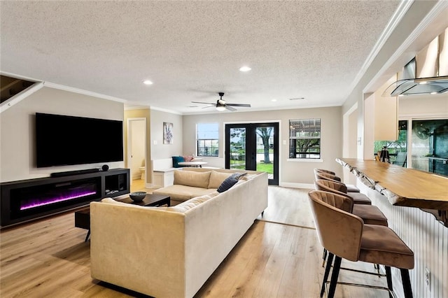 352 Moonraker Dr, Slidell, LA 70461 - living area featuring a textured ceiling, crown molding, light wood finished floors, recessed lighting, and a ceiling fan