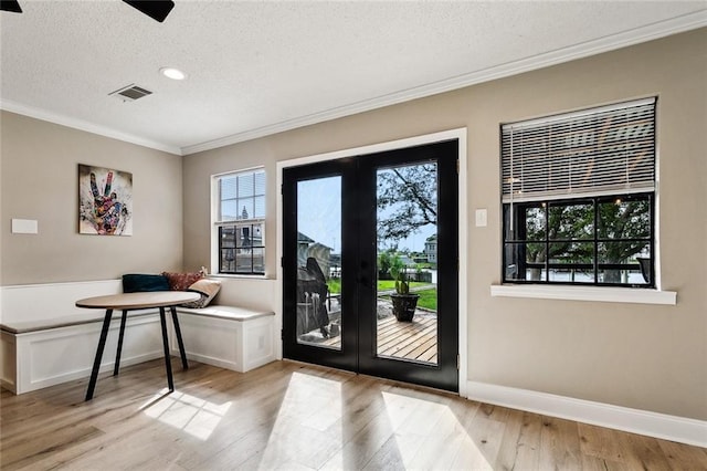 352 Moonraker Dr, Slidell, LA 70461 - foyer featuring a textured ceiling, crown molding, plenty of natural light, light wood-style floors, and baseboards