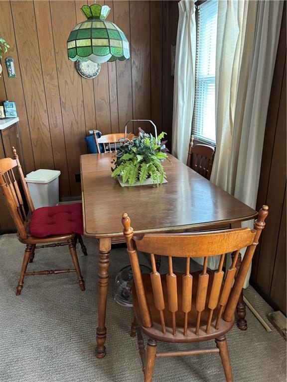 905 Lurline Dr, Jefferson, LA 70121 - carpeted dining space featuring wood walls