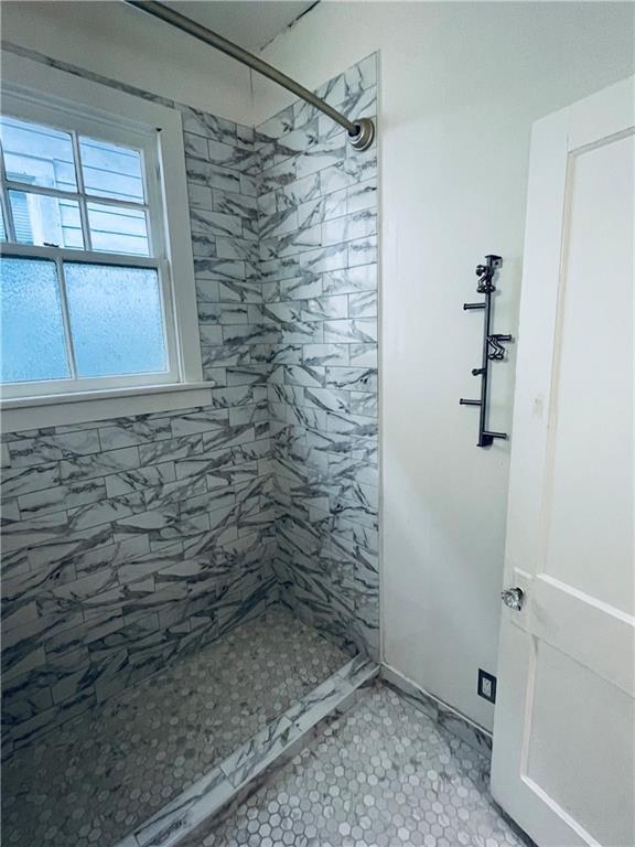905-907 Pelican Ave, New Orleans, LA 70114 - full bathroom with a stall shower and tile patterned floors