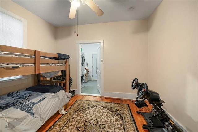 905-907 Pelican Ave, New Orleans, LA 70114 - bedroom with stacked washer / dryer, wood finished floors, baseboards, and ceiling fan