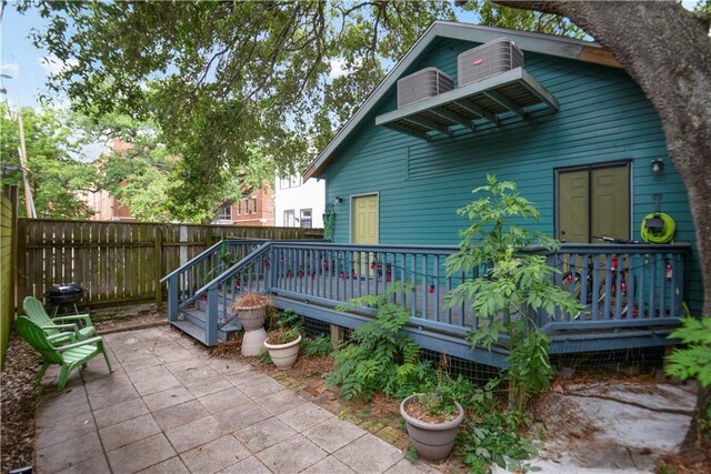 905-907 Pelican Ave, New Orleans, LA 70114 - rear view of property with a patio area, a wooden deck, and a fenced backyard