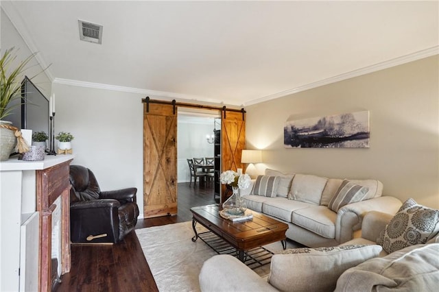 1112 Michigan Ave, Kenner, LA 70062 - living room featuring a barn door, crown molding, wood finished floors, and baseboards