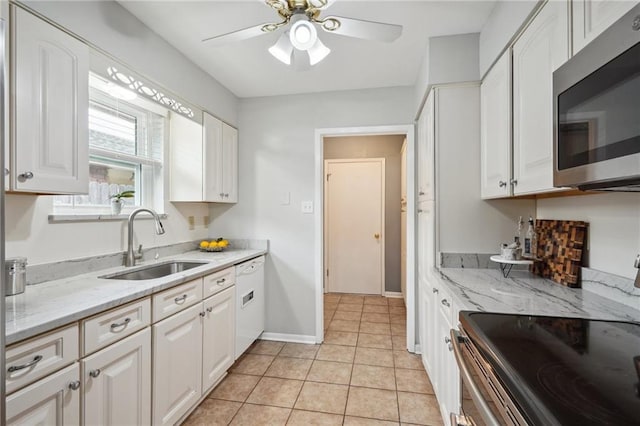 1112 Michigan Ave, Kenner, LA 70062 - kitchen featuring appliances with stainless steel finishes, a sink, a ceiling fan, white cabinets, and light tile patterned floors