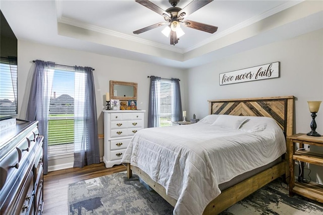 28272 Lake Salvador Dr, Livingston, LA 70754 - bedroom featuring a tray ceiling, crown molding, wood finished floors, ceiling fan, and baseboards