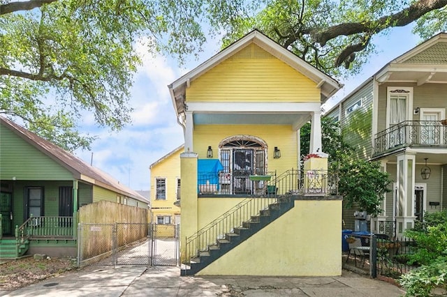 1534 N Dorgenois St, New Orleans, LA 70119 - shotgun-style home featuring a gate, stairs, and a porch