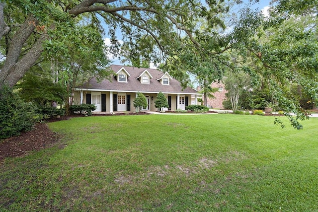 553 Beau Chene Dr, Mandeville, LA 70471 - cape cod-style house featuring a front lawn and covered porch