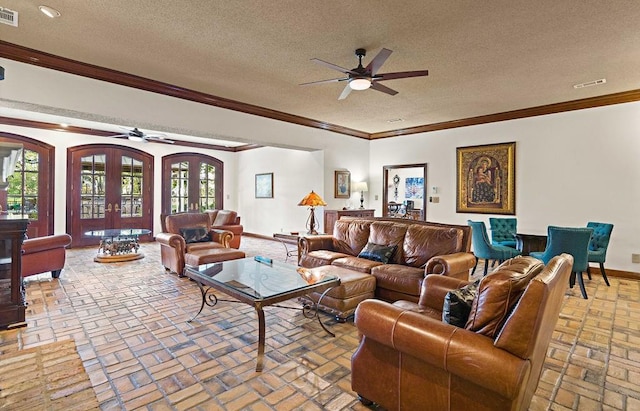 553 Beau Chene Dr, Mandeville, LA 70471 - living room featuring ceiling fan, brick flooring, crown molding, arched walkways, and a textured ceiling