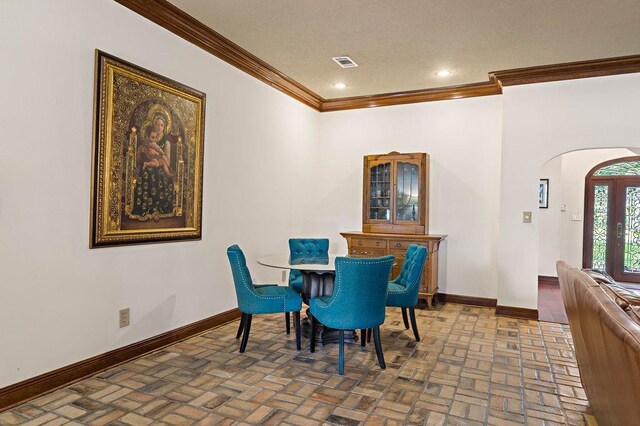 553 Beau Chene Dr, Mandeville, LA 70471 - dining room featuring arched walkways, ornamental molding, brick flooring, and recessed lighting