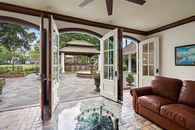 553 Beau Chene Dr, Mandeville, LA 70471 - entryway featuring french doors, ornamental molding, ceiling fan, and a textured ceiling