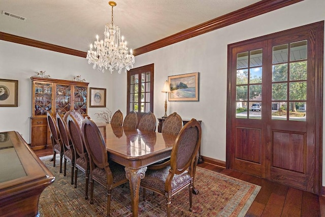 553 Beau Chene Dr, Mandeville, LA 70471 - dining area with a chandelier, crown molding, and wood-type flooring