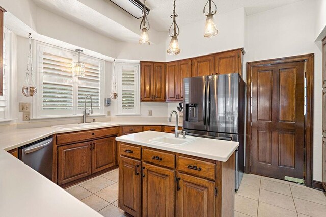 553 Beau Chene Dr, Mandeville, LA 70471 - kitchen with light tile patterned flooring, appliances with stainless steel finishes, light countertops, and brown cabinets