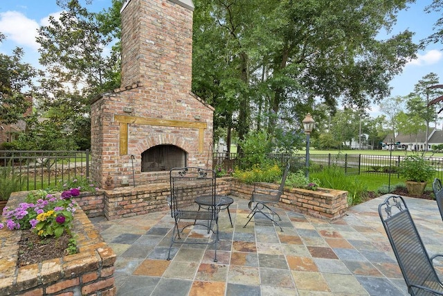 553 Beau Chene Dr, Mandeville, LA 70471 - view of patio / terrace featuring an outdoor brick fireplace