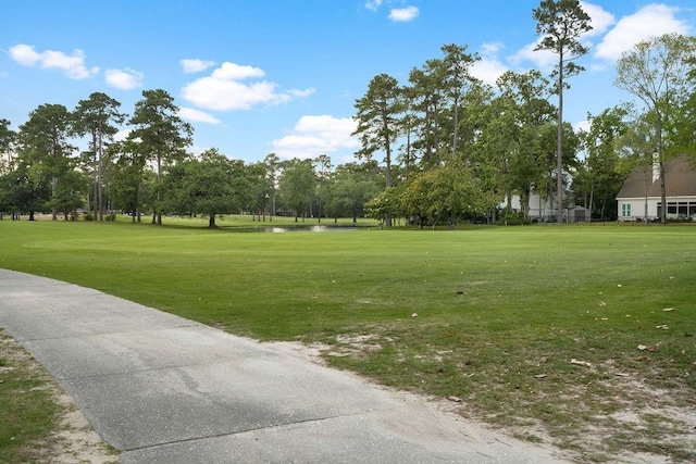 553 Beau Chene Dr, Mandeville, LA 70471 - view of home's community featuring a lawn, view of wooded area, and golf course view