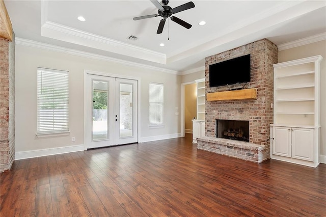 47075 Weald Way, Hammond, LA 70401 - unfurnished living room featuring a fireplace, a ceiling fan, dark wood finished floors, a raised ceiling, and baseboards