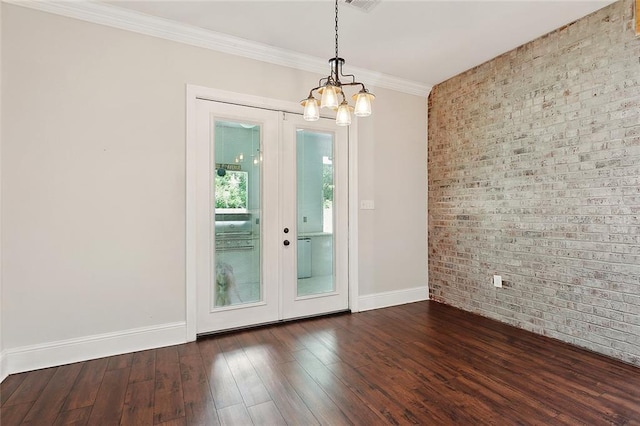 47075 Weald Way, Hammond, LA 70401 - spare room featuring brick wall, a chandelier, baseboards, french doors, and wood finished floors