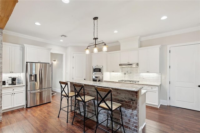 47075 Weald Way, Hammond, LA 70401 - kitchen with appliances with stainless steel finishes, under cabinet range hood, decorative backsplash, white cabinetry, and recessed lighting