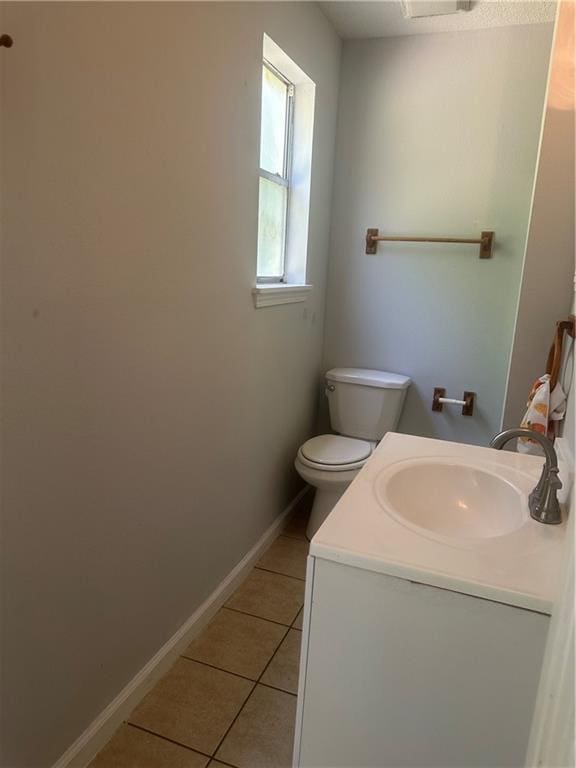25594 W Spruce St, Lacombe, LA 70445 - bathroom with tile patterned flooring, toilet, baseboards, and vanity