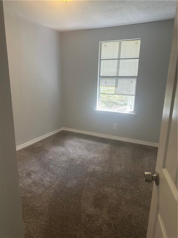 25594 W Spruce St, Lacombe, LA 70445 - carpeted spare room featuring a textured ceiling and baseboards