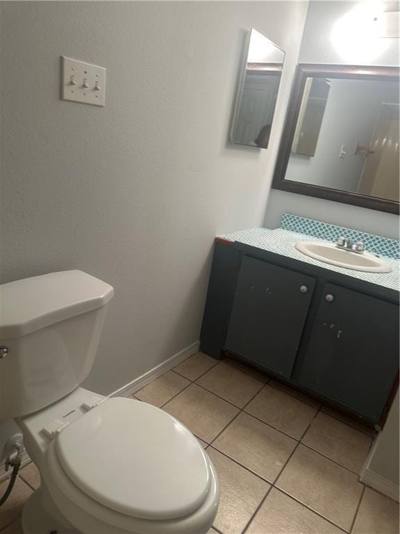 25594 W Spruce St, Lacombe, LA 70445 - half bath featuring toilet, vanity, tile patterned floors, and baseboards