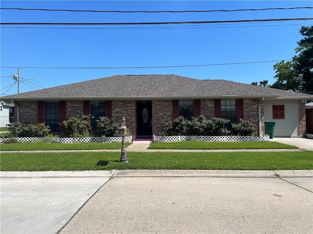 4300 Idaho Ave, Kenner, LA 70065 - single story home featuring a front lawn, brick siding, and roof with shingles