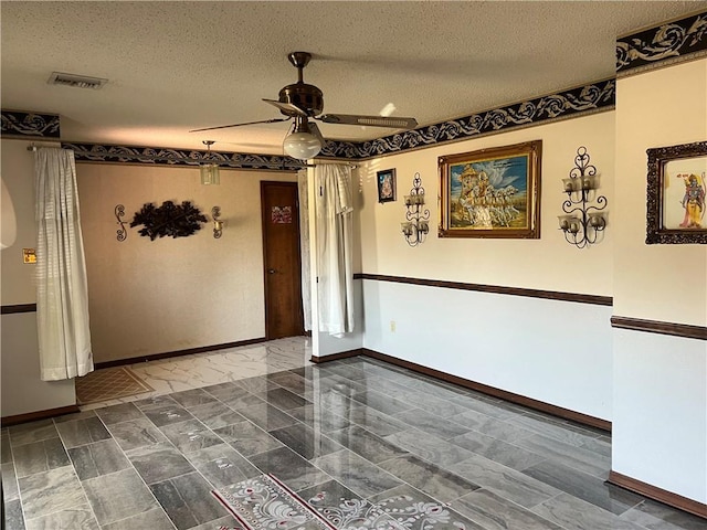4300 Idaho Ave, Kenner, LA 70065 - empty room with ceiling fan, baseboards, and a textured ceiling